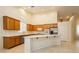 Well-lit kitchen with stainless appliances, long island, and lots of cabinet storage at 11204 Newbury Hills Ave, Las Vegas, NV 89138