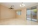 Open-plan living area featuring tile floors, a ceiling fan, recessed lights, and sliding patio doors at 11204 Newbury Hills Ave, Las Vegas, NV 89138