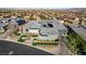 An aerial view displays a well-maintained home with gray tile roof and modern desert landscaping at 11296 Villa Bellagio Dr, Las Vegas, NV 89141