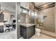 Modern bathroom with dark vanity, glass-enclosed shower, and contemporary fixtures at 11296 Villa Bellagio Dr, Las Vegas, NV 89141