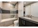 Modern bathroom featuring sleek tiling, vanity with sink, and shower over tub at 11296 Villa Bellagio Dr, Las Vegas, NV 89141