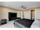 This contemporary bedroom includes a ceiling fan, TV, and ensuite bathroom at 11296 Villa Bellagio Dr, Las Vegas, NV 89141