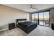 Modern bedroom boasts a ceiling fan and sliding glass doors to outdoor space at 11296 Villa Bellagio Dr, Las Vegas, NV 89141