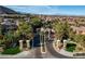 A stately gated community entrance surrounded by mature trees and manicured landscaping at 11296 Villa Bellagio Dr, Las Vegas, NV 89141