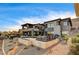 Stunning two-story home with an inviting patio, outdoor furniture and lush landscaping at 11296 Villa Bellagio Dr, Las Vegas, NV 89141