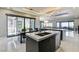 Open-concept kitchen featuring modern appliances, an island, dark cabinets, and a seamless flow into the dining area at 11296 Villa Bellagio Dr, Las Vegas, NV 89141