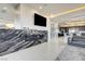 Modern living room featuring a marble fireplace, TV, and wine cellar next to the stylish, open kitchen at 11296 Villa Bellagio Dr, Las Vegas, NV 89141