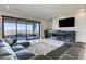 Living area with sliding glass doors to the patio, a fireplace, and modern furnishings at 11296 Villa Bellagio Dr, Las Vegas, NV 89141