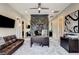 Well-lit office area with a gray rug, a brown leather sofa and a modern desk at 11296 Villa Bellagio Dr, Las Vegas, NV 89141