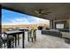 Beautiful covered patio featuring tile flooring, a ceiling fan, mountain views, and an outdoor kitchen at 11296 Villa Bellagio Dr, Las Vegas, NV 89141