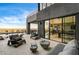 Cozy outdoor patio featuring comfortable seating, glass fire pits, and sliding doors to the indoors at 11296 Villa Bellagio Dr, Las Vegas, NV 89141