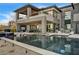 Beautiful outdoor living area with pool, spa, lounge chairs, and covered seating area at 11296 Villa Bellagio Dr, Las Vegas, NV 89141