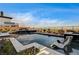 Stunning modern pool with integrated lounge chairs and a beautiful view of the landscape at 11296 Villa Bellagio Dr, Las Vegas, NV 89141