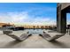 Inviting pool area featuring lounge chairs, a sleek pool design, and serene desert views at 11296 Villa Bellagio Dr, Las Vegas, NV 89141