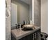 Stylish powder room featuring a vessel sink and sleek black toilet at 11296 Villa Bellagio Dr, Las Vegas, NV 89141