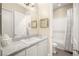 Bright bathroom with marble countertops, white cabinetry, and a separate shower and toilet area at 12217 Tempestad Ave, Las Vegas, NV 89138