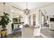 Bright and airy dining area with a large window and an adjacent living space at 12217 Tempestad Ave, Las Vegas, NV 89138