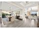 Bright and open dining room, featuring a large table and chairs, opens to the living room and outdoor space at 12217 Tempestad Ave, Las Vegas, NV 89138