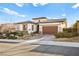 An exterior shot shows the home's desert landscaping and a side-entry two-car garage at 12217 Tempestad Ave, Las Vegas, NV 89138