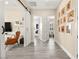 Bright hallway with grey wood floors, barn door and decorative accents at 12217 Tempestad Ave, Las Vegas, NV 89138