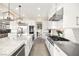 Bright kitchen featuring white cabinets, stainless steel appliances, and a large island with a sink at 12217 Tempestad Ave, Las Vegas, NV 89138