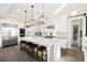 Modern white kitchen with stainless steel appliances, a large center island, and pendant lighting at 12217 Tempestad Ave, Las Vegas, NV 89138