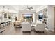 Spacious living room with built in shelving, large windows and a view into the kitchen at 12217 Tempestad Ave, Las Vegas, NV 89138