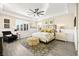 A luxurious main bedroom featuring a coffered ceiling, a ceiling fan, decorative rug, and access to the bathroom at 12217 Tempestad Ave, Las Vegas, NV 89138