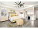 A sunlit main bedroom features a decorative ceiling fan, an ottoman, and a beverage center at 12217 Tempestad Ave, Las Vegas, NV 89138