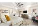 A luxurious main bedroom featuring a coffered ceiling, a ceiling fan, decorative rug, and access to the bathroom at 12217 Tempestad Ave, Las Vegas, NV 89138