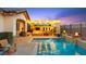 Inviting backyard pool with a covered outdoor kitchen, fire pit, and beautiful travertine tile deck at 12217 Tempestad Ave, Las Vegas, NV 89138