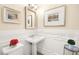 Stylish powder room featuring elegant wainscoting, a pedestal sink, and decorative accents at 12217 Tempestad Ave, Las Vegas, NV 89138