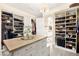 Spacious walk-in closet featuring custom shelving and central storage island at 12217 Tempestad Ave, Las Vegas, NV 89138