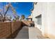 Backyard view of patio, block wall and stucco exterior of house on a sunny day at 2049 Audrey Hepburn St, Las Vegas, NV 89142