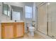 Bright bathroom features a vanity with wood cabinets and a glass shower at 2049 Audrey Hepburn St, Las Vegas, NV 89142