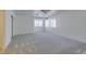 Bright bedroom featuring neutral walls, gray carpet, and natural light at 2049 Audrey Hepburn St, Las Vegas, NV 89142