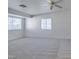 Well-lit bedroom featuring neutral carpeting, ceiling fan, and bright windows at 2049 Audrey Hepburn St, Las Vegas, NV 89142