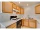 Well-organized kitchen featuring white counters, classic wooden cabinets, and modern appliances at 2049 Audrey Hepburn St, Las Vegas, NV 89142