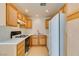 Kitchen area with tiled flooring, wooden cabinets, white countertops and a modern gas stove at 2049 Audrey Hepburn St, Las Vegas, NV 89142