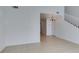 Bright living room featuring tile flooring and a staircase at 2049 Audrey Hepburn St, Las Vegas, NV 89142