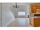 Open living room with a chandelier, fireplace, tile floors, and a connecting kitchen area at 2049 Audrey Hepburn St, Las Vegas, NV 89142