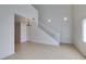 Bright living room featuring high ceilings, tile flooring, and a staircase at 2049 Audrey Hepburn St, Las Vegas, NV 89142