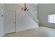 Bright living room featuring high ceilings, tile flooring, and a staircase at 2049 Audrey Hepburn St, Las Vegas, NV 89142