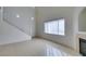 Bright living room featuring high ceilings, tile flooring, a fireplace, and a staircase at 2049 Audrey Hepburn St, Las Vegas, NV 89142