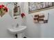 Powder room featuring pedestal sink, decorative mirror, and patterned towels at 2050 Los Feliz St # 112, Las Vegas, NV 89156