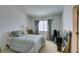 Serene bedroom with soft gray bedding, ample natural light, and carpet flooring at 2050 Los Feliz St # 112, Las Vegas, NV 89156