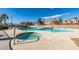 Community pool featuring pool, hot tub, mature palm trees and clear blue skies at 2050 Los Feliz St # 112, Las Vegas, NV 89156