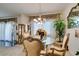 Bright dining room with a glass table, elegant chairs, and views of the living room at 2050 Los Feliz St # 112, Las Vegas, NV 89156