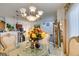 Formal dining room with glass table, ornate chairs and decorative lighting at 2050 Los Feliz St # 112, Las Vegas, NV 89156