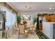 Charming dining room with a glass-top table, chandelier, and access to kitchen at 2050 Los Feliz St # 112, Las Vegas, NV 89156